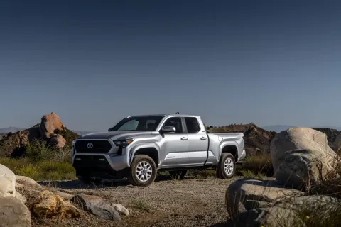 Toyota Tacoma pickup truck on a rocky desert trail.